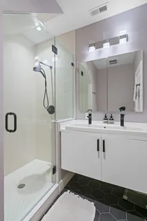 a bathroom with a sink a mirror and a shower