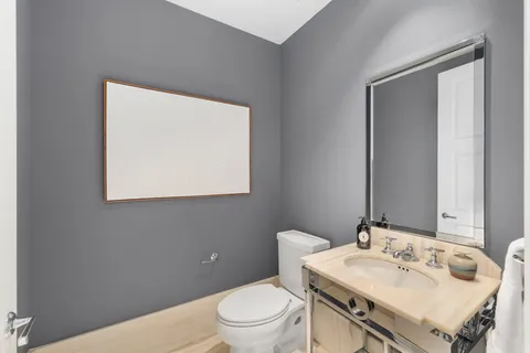 a bathroom with a sink a toilet and mirror