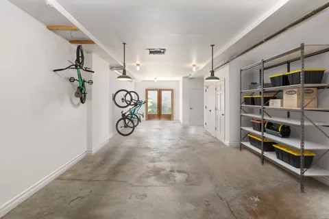 a backyard with table and chairs with potted plants