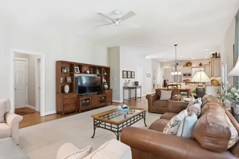a living room with furniture a rug and a lamp