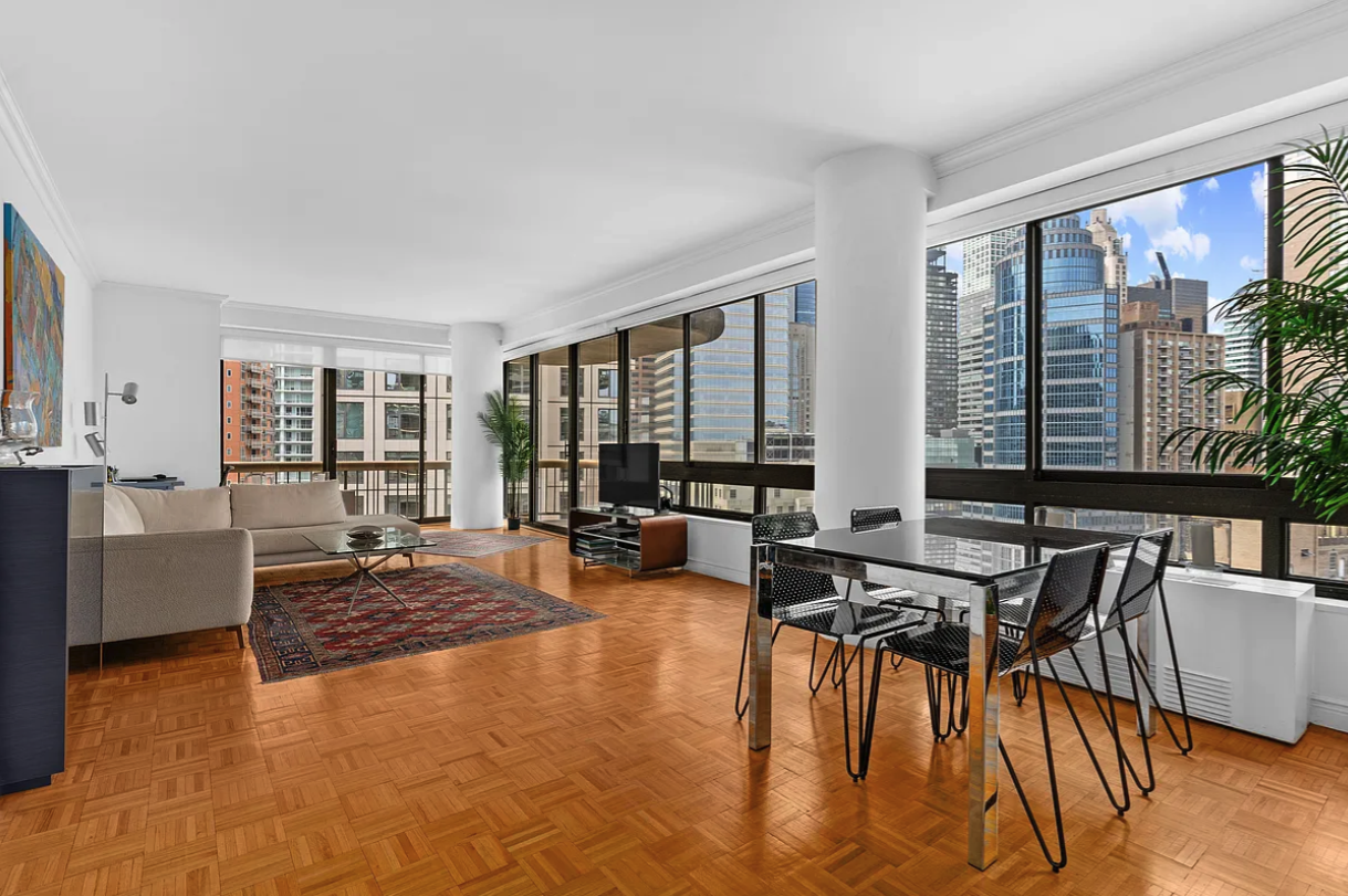 167 East 61st Street, Unit 21B Manhattan, NY 10065 - Photo 2 of 12 a living room with furniture and floor to ceiling windows