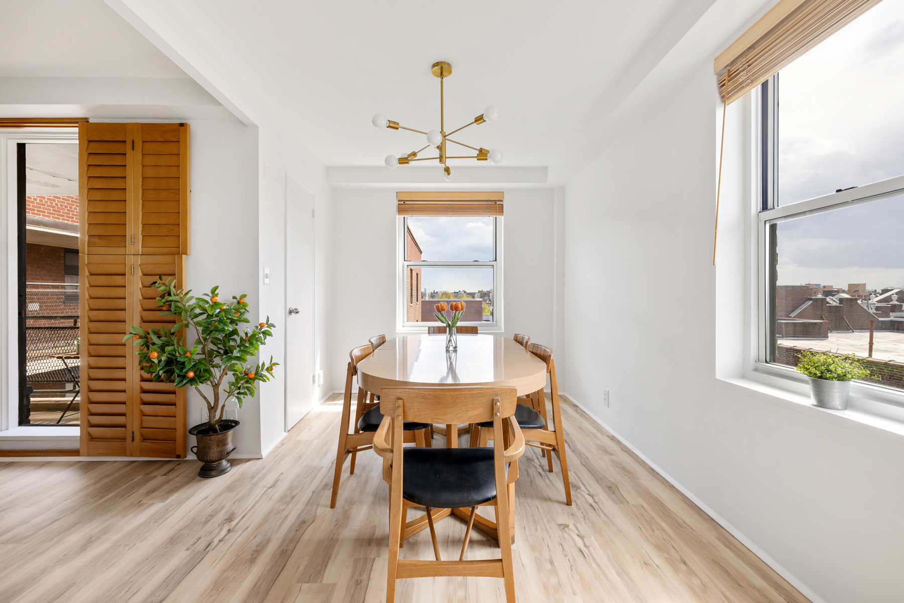 35-50 85th Street, Unit 9E Queens, NY 11372 - Photo 5 of 13 a view of a dining room with furniture window and wooden floor