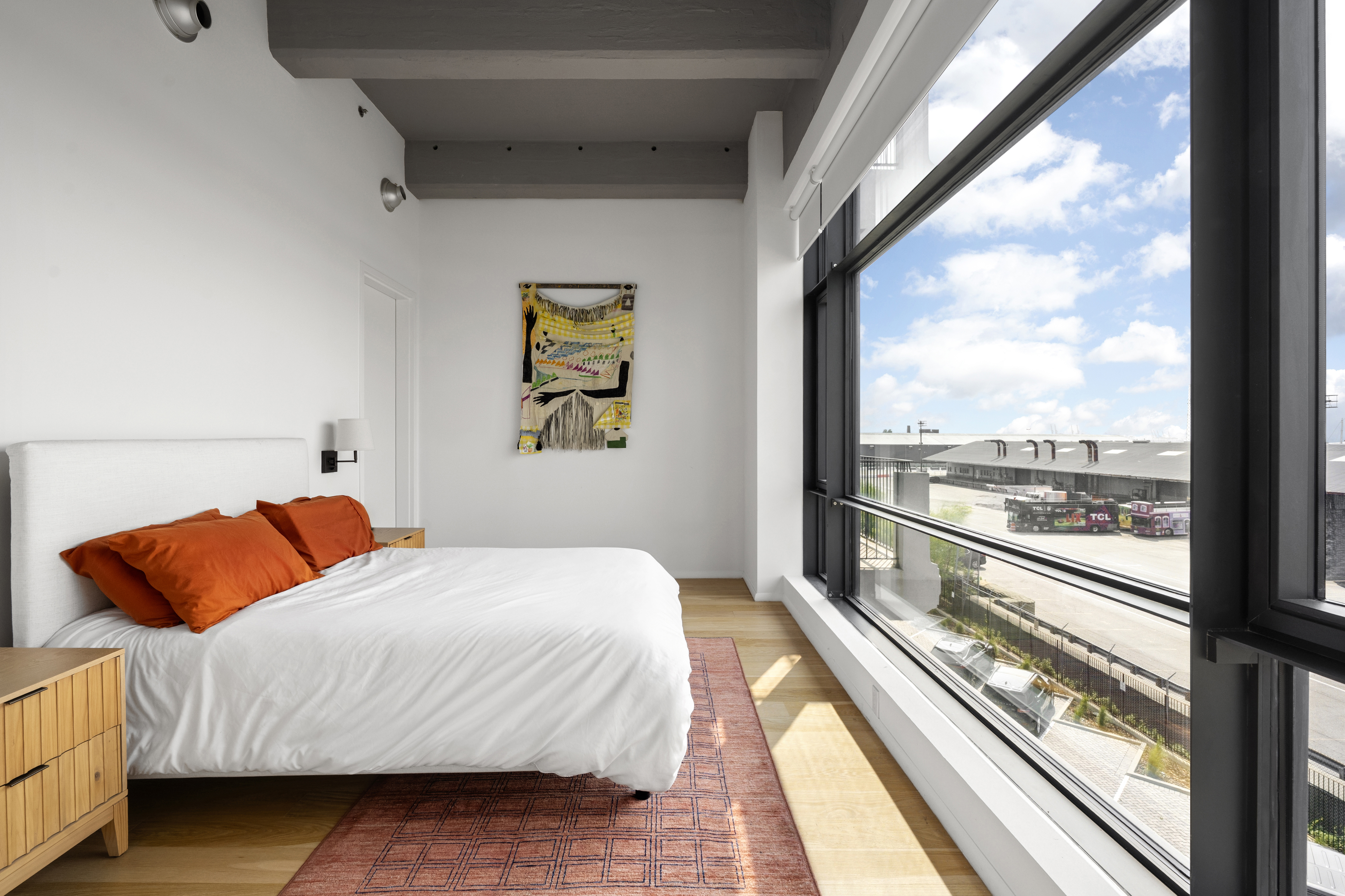 160 Imlay Street, Unit 3B3 Brooklyn, NY 11231 - Photo 7 of 14 a bedroom with a bed and glass windows