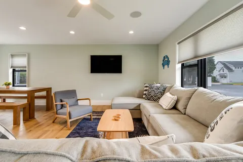 a living room with couches and a flat screen tv