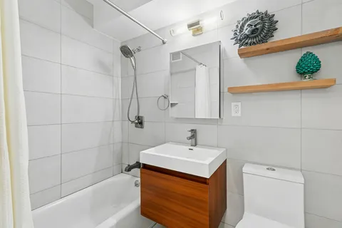 a bathroom with a sink a mirror and shower