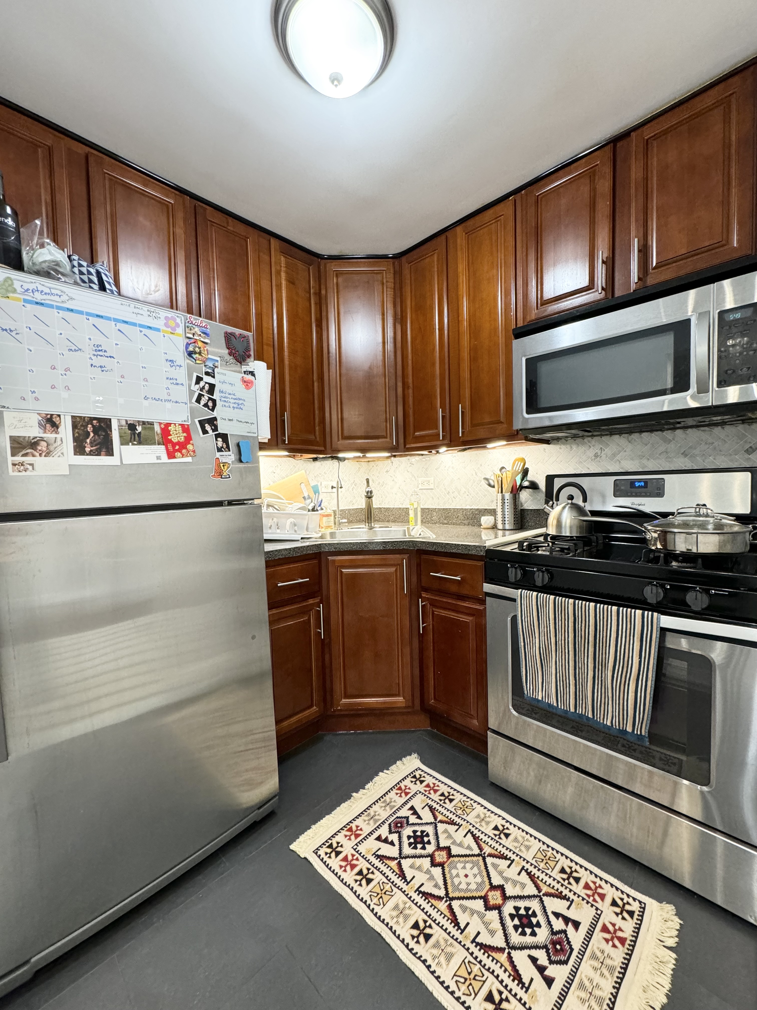 310 Lenox Road, Unit 4D Brooklyn, NY 11226 - Photo 5 of 14 a kitchen with a refrigerator stove and wooden cabinets