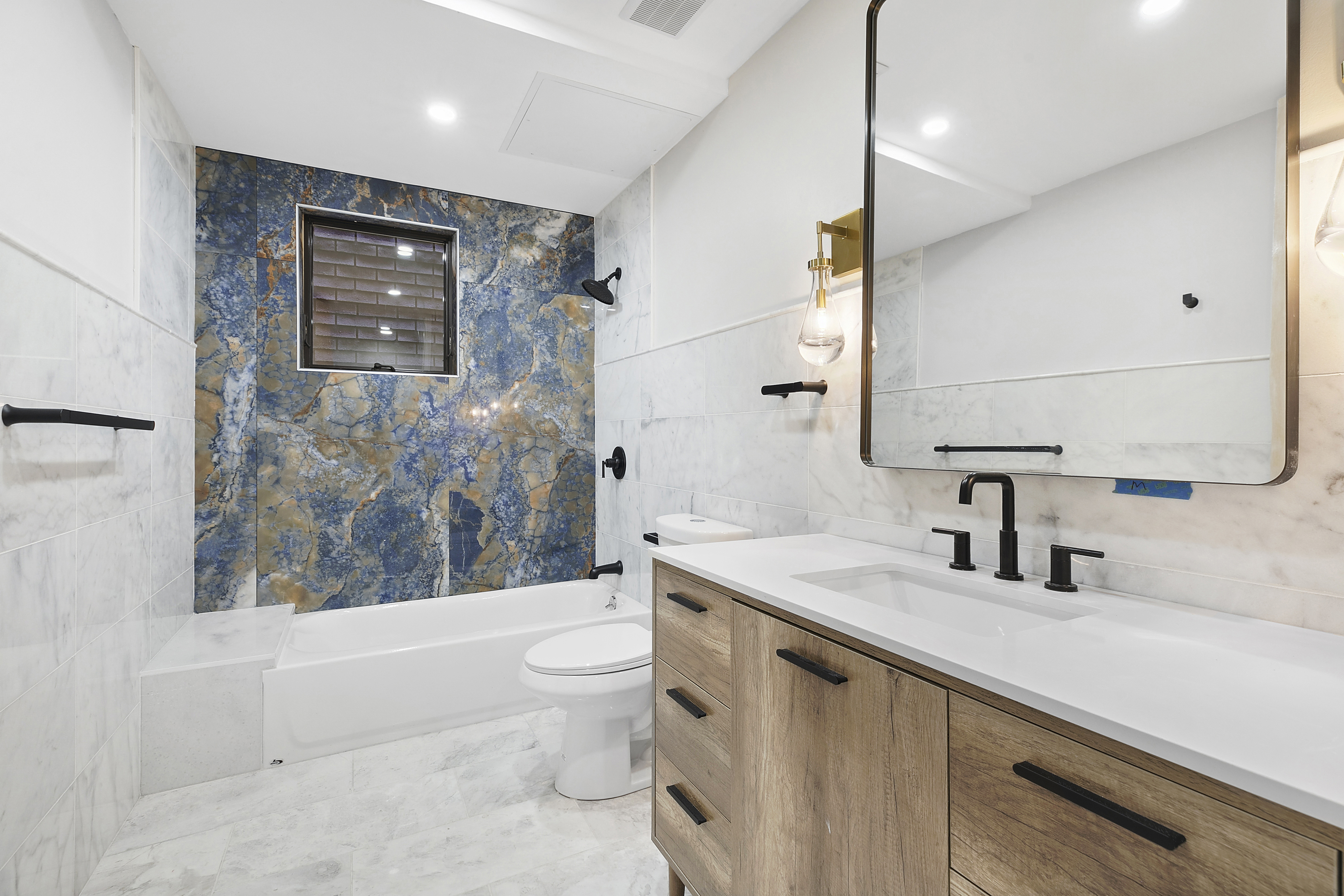 35-17 30th Street, Unit GARDEN Queens, NY 11106 - Photo 3 of 14 a bathroom with a sink a toilet and bathtub