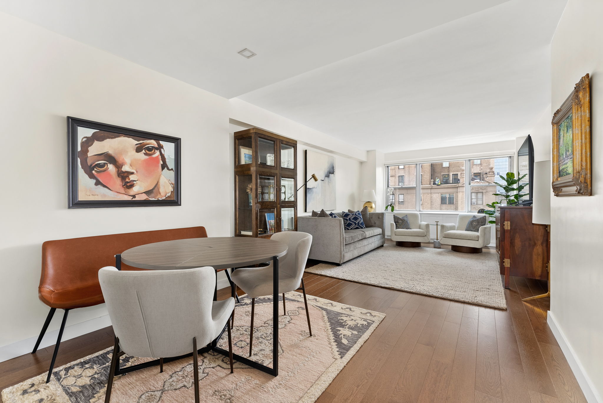 15 West 72nd Street, Unit 22O Manhattan, NY 10023 - Photo 2 of 8 a living room with furniture and a large window