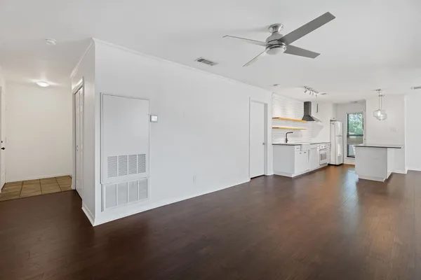 a view of a kitchen with a sink and a refrigerator