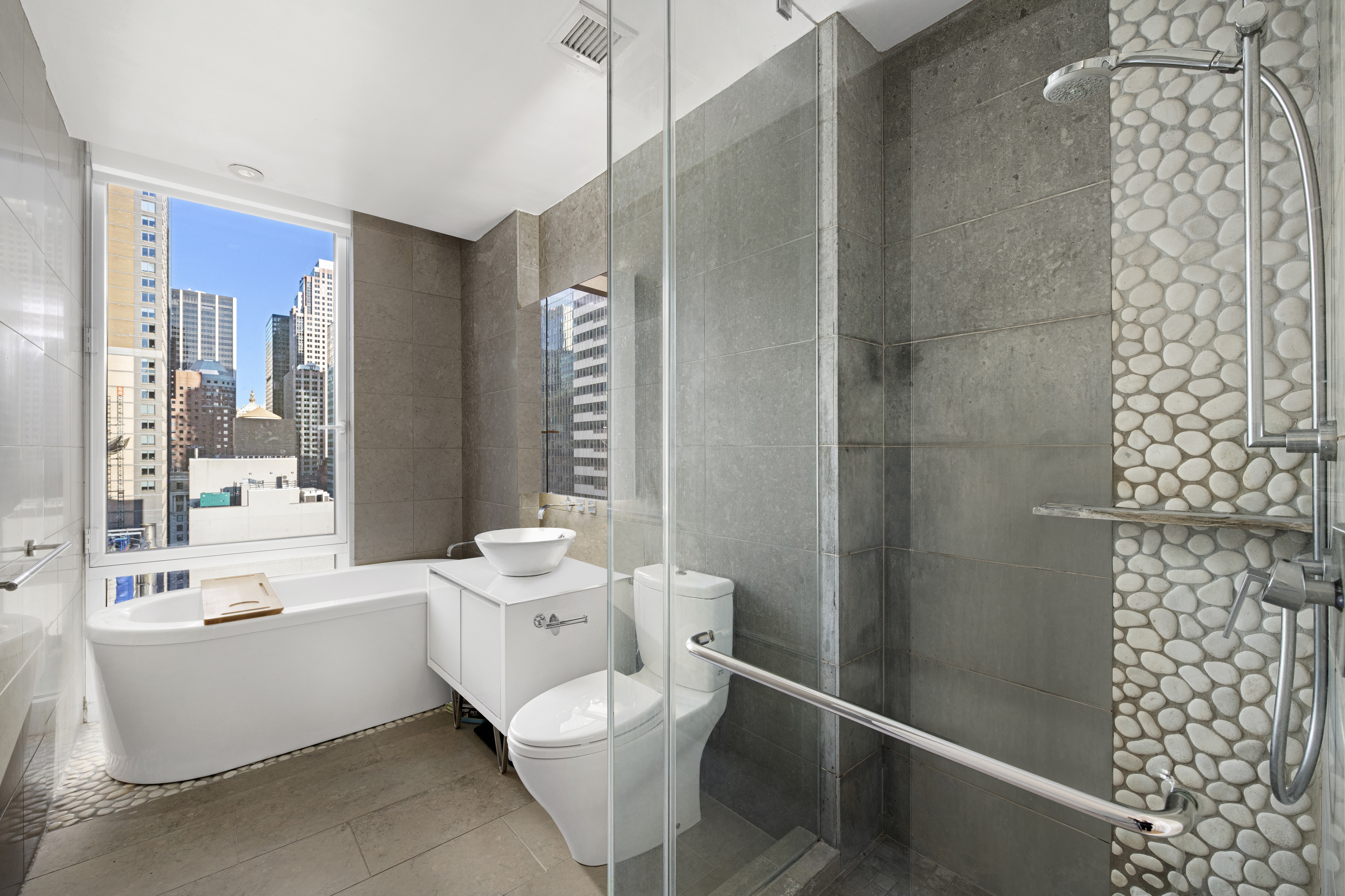 247 West 46th Street, Unit 2305 Manhattan, NY 10036 - Photo 8 of 13 a room with a bathtub and shower