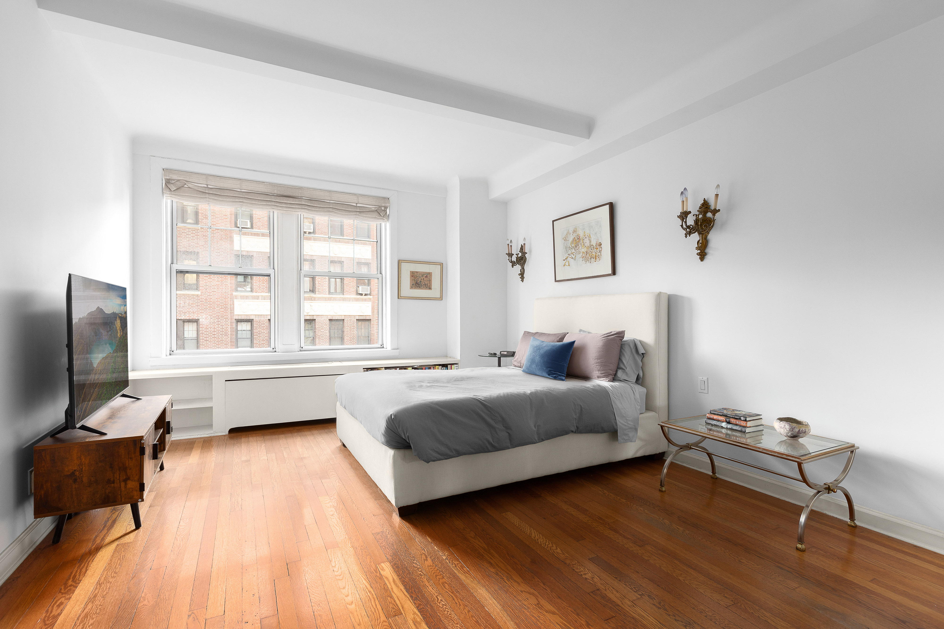 575 Park Avenue, Unit 407 Manhattan, NY 10065 - Photo 5 of 14 a bedroom with a bed and wooden floor