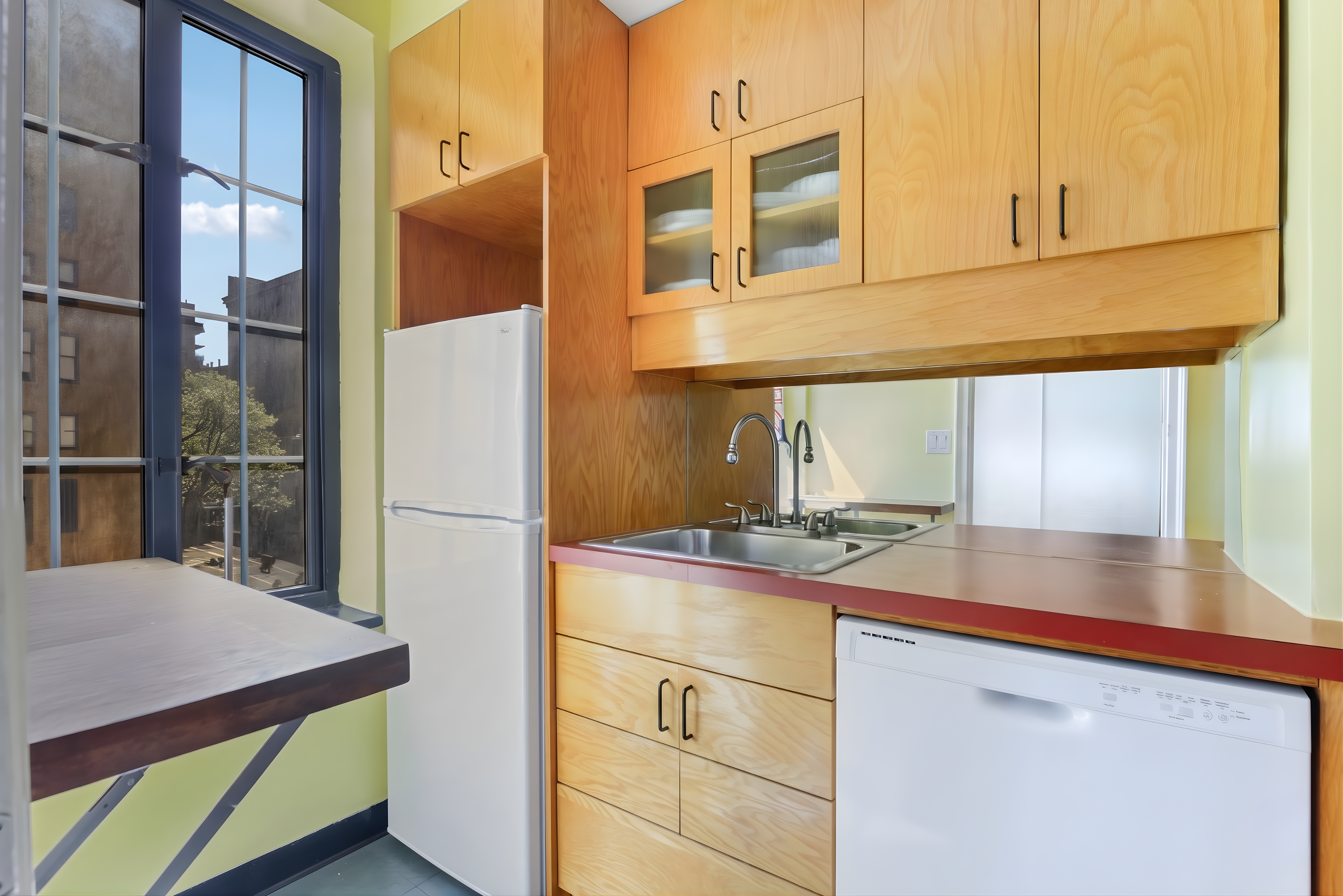 201 West 16th Street, Unit 3C Manhattan, NY 10011 - Photo 4 of 11 a kitchen with a refrigerator and countertop