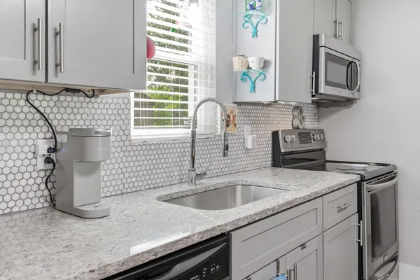 a kitchen with a sink cabinets and window