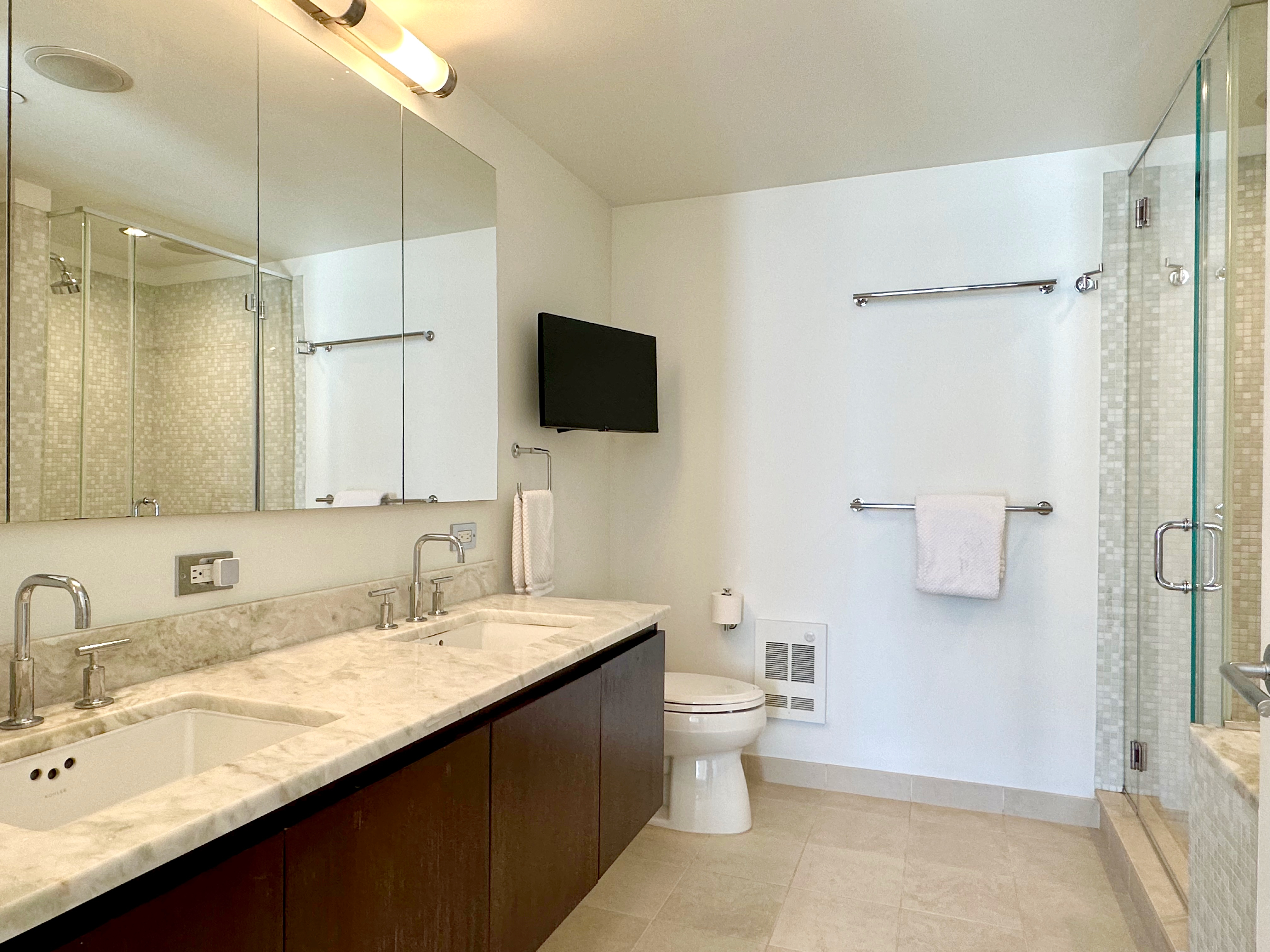 350 West 53rd Street, Unit PHA Manhattan, NY 10019 - Photo 15 of 35 a bathroom with a double vanity sink a toilet and mirror