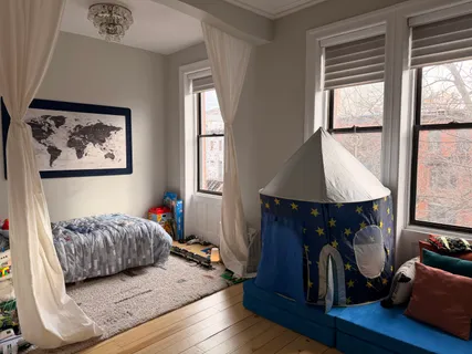 a bedroom with furniture and a window