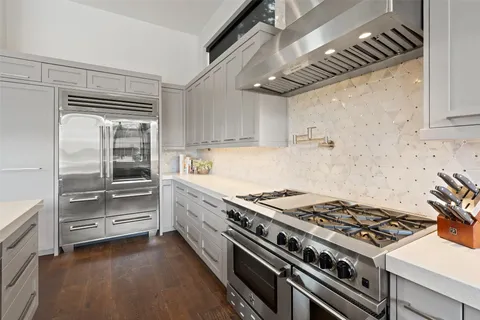 a kitchen with granite countertop a stove and a refrigerator