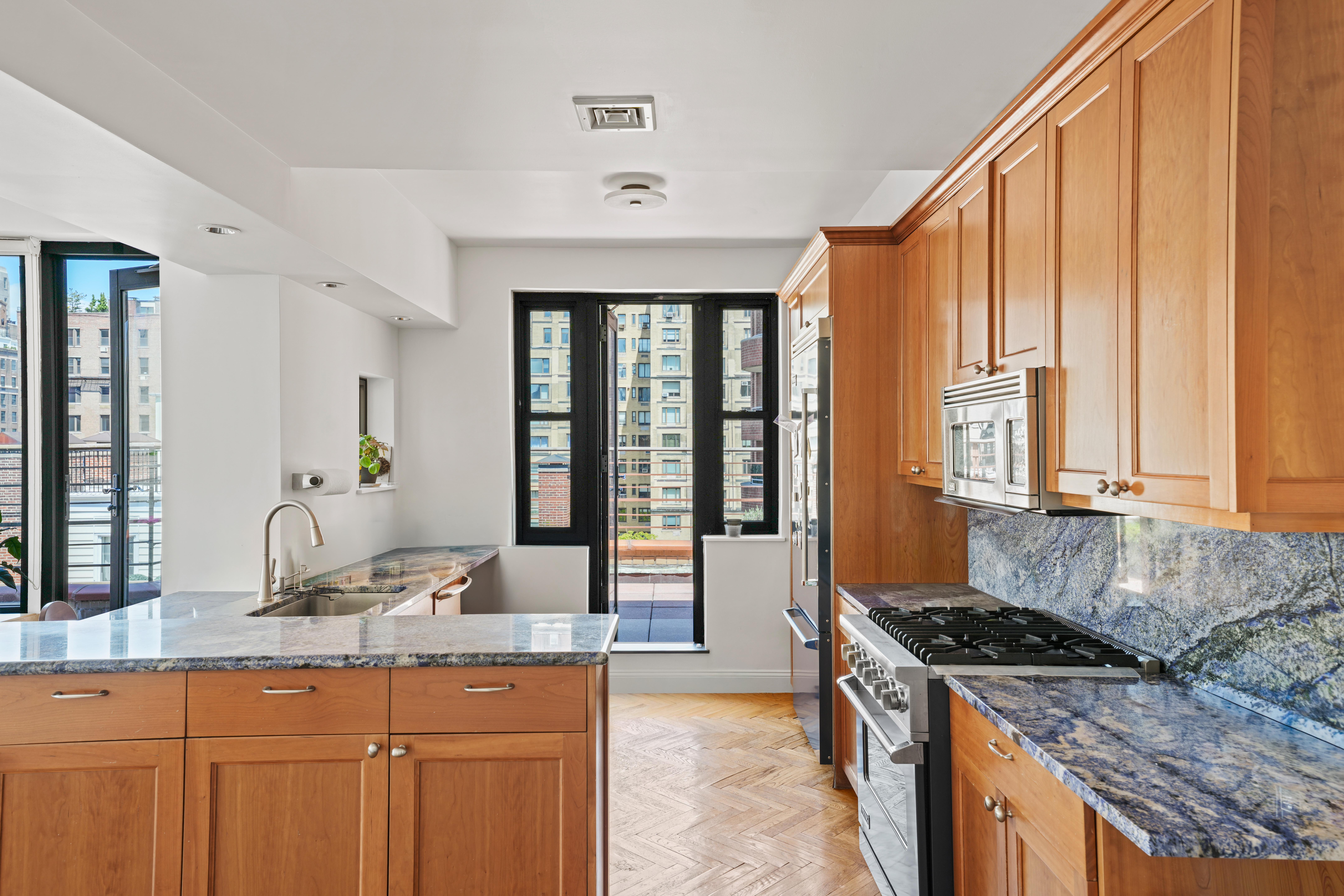 177 East 77th Street, Unit PHC Manhattan, NY 10075 - Photo 8 of 26 a spacious kitchen with granite countertop a sink and a window