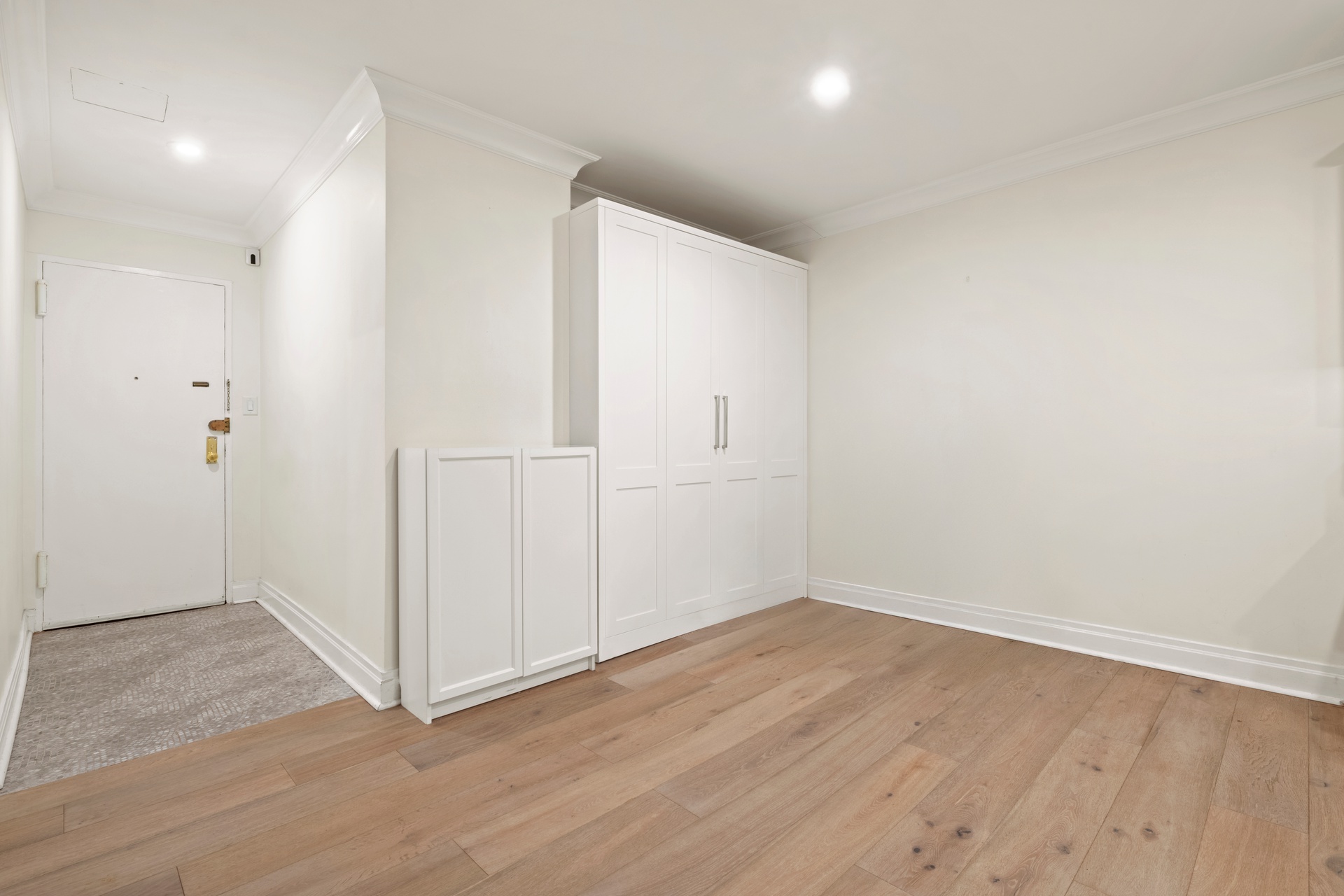 440 East 57th Street, Unit 1G Manhattan, NY 10022 - Photo 9 of 10 an empty room with wooden floor and white doors