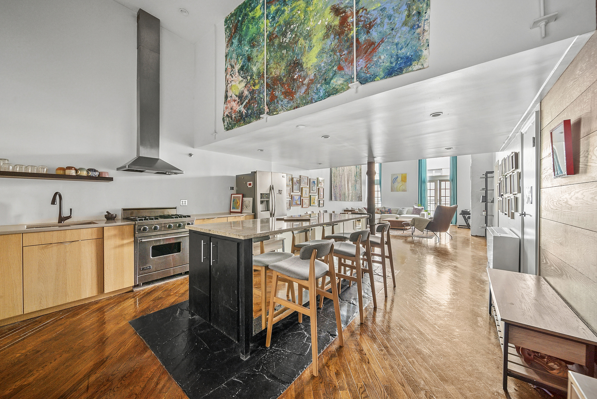 121 West 20th Street, Unit 3C Manhattan, NY 10011 - Photo 3 of 10 a kitchen with stainless steel appliances granite countertop a stove and a wooden floors