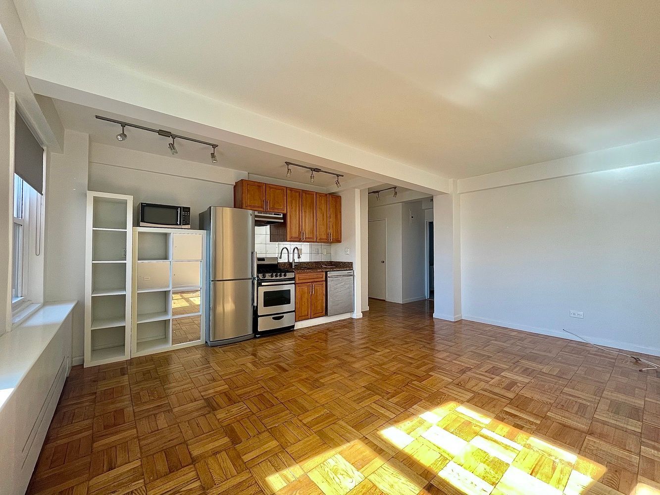 345 West 145th Street, Unit 8A1 Manhattan, NY 10031 - Photo 2 of 7 a view of a kitchen with refrigerator and windows