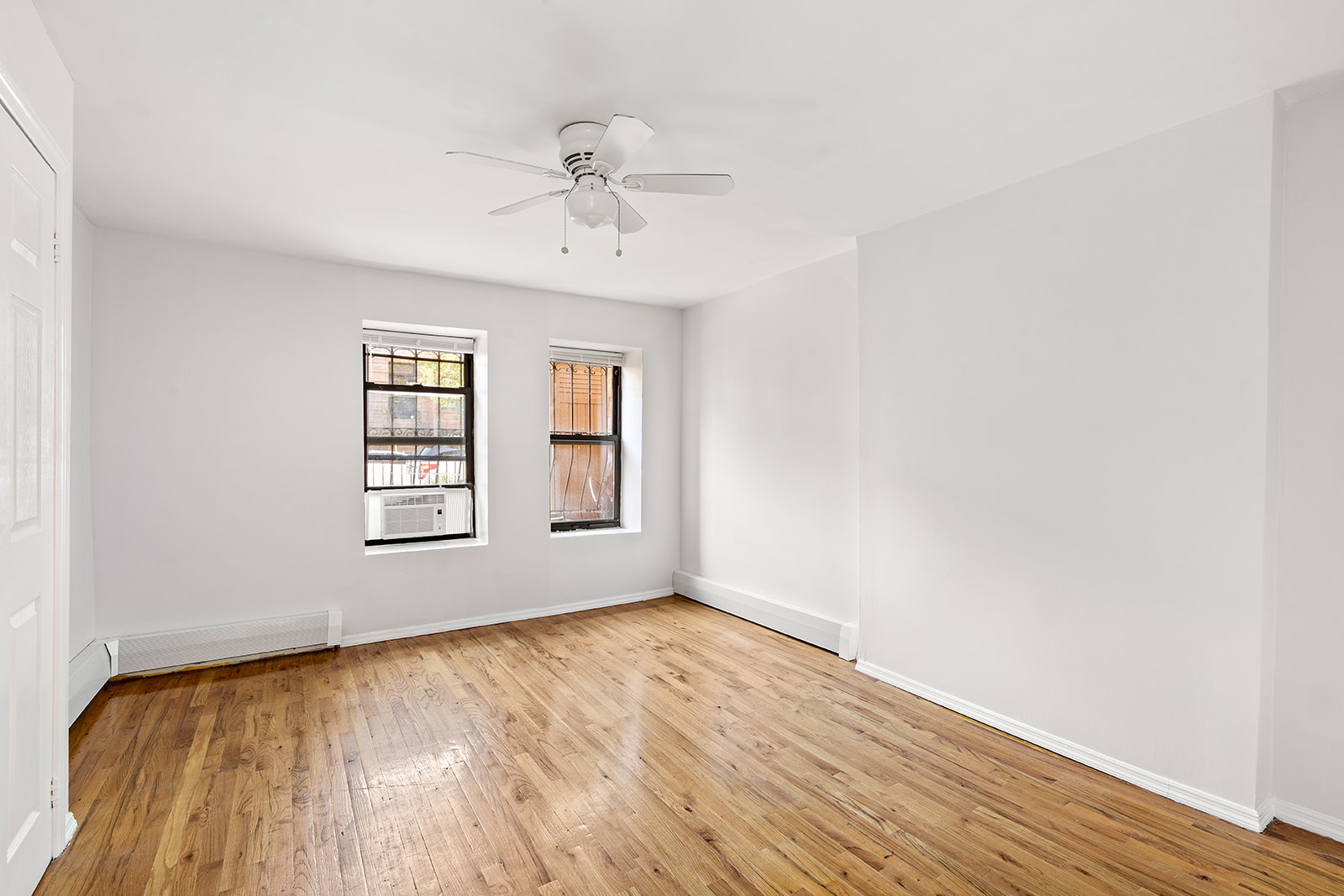 383 Bainbridge Street, Unit 1 Brooklyn, NY 11233 - Photo 8 of 14 wooden floor in an empty room with a window