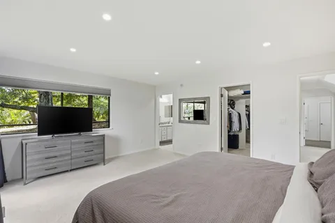 a bedroom with a bed and flat screen tv