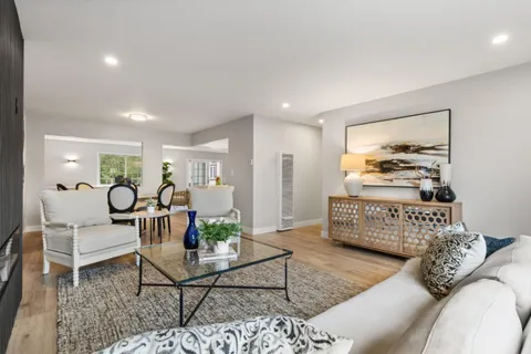 a dining room with furniture and wooden floor