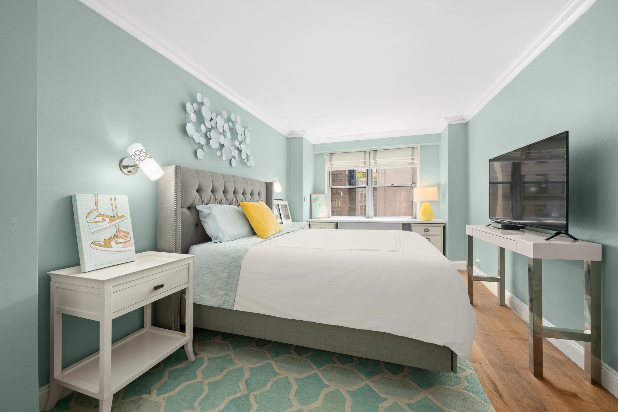 10 West 15th Street, Unit 1027/1028 Manhattan, NY 10011 - Photo 11 of 15 a bedroom with a bed and a flat screen tv