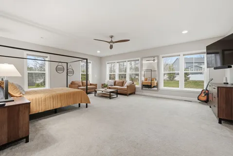 a bed room with furniture and a large window