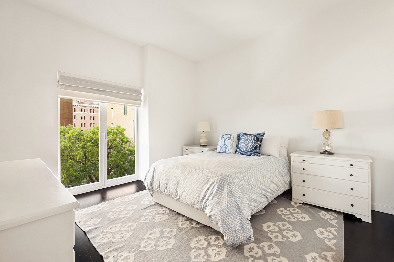 400 West 12th Street, Unit 4J Manhattan, NY 10014 - Photo 9 of 21 a bedroom with a bed and a window