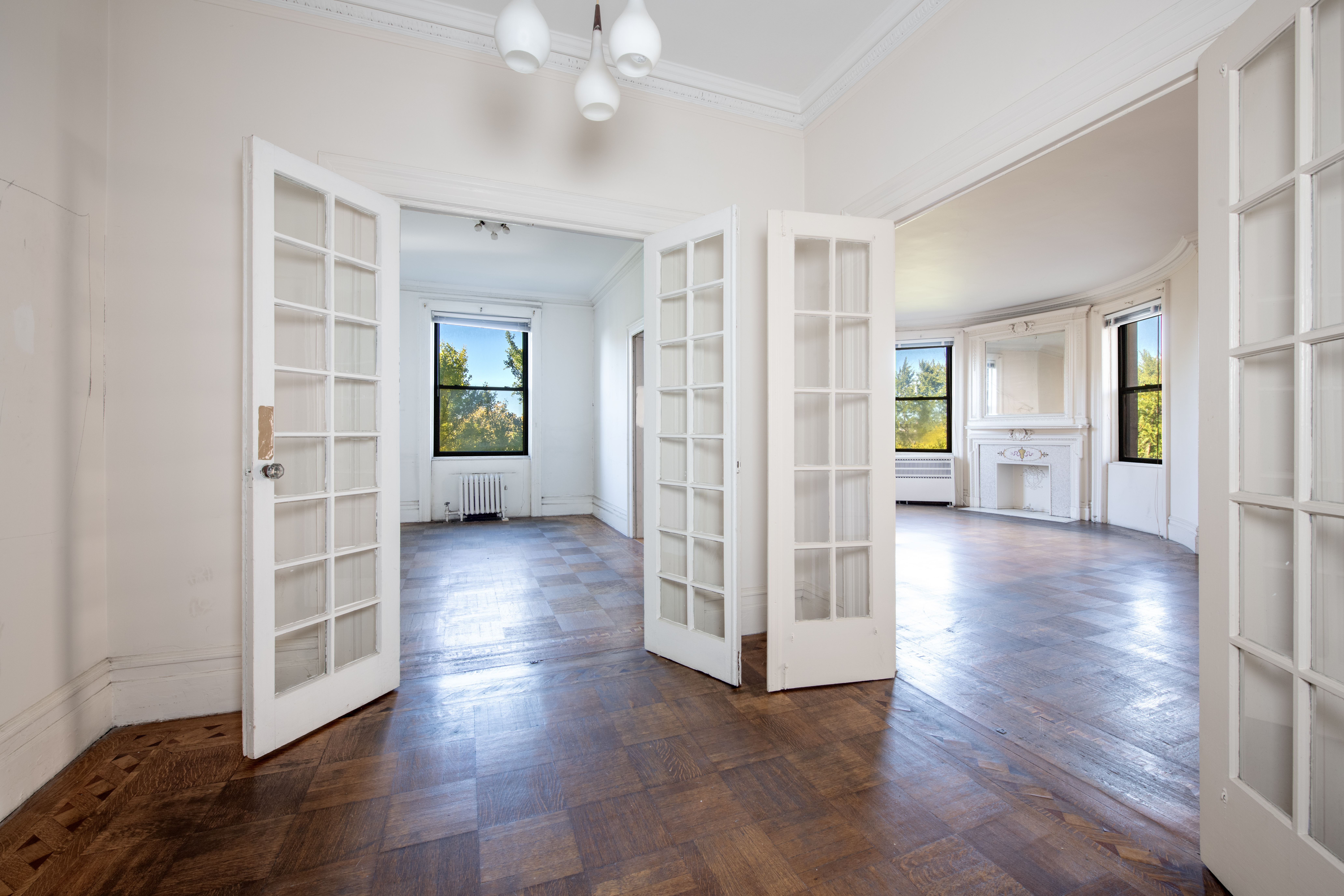 194 Riverside Drive, Unit 5E Manhattan, NY 10025 - Photo 7 of 26 a view of a big room with wooden floor windows and cabinet