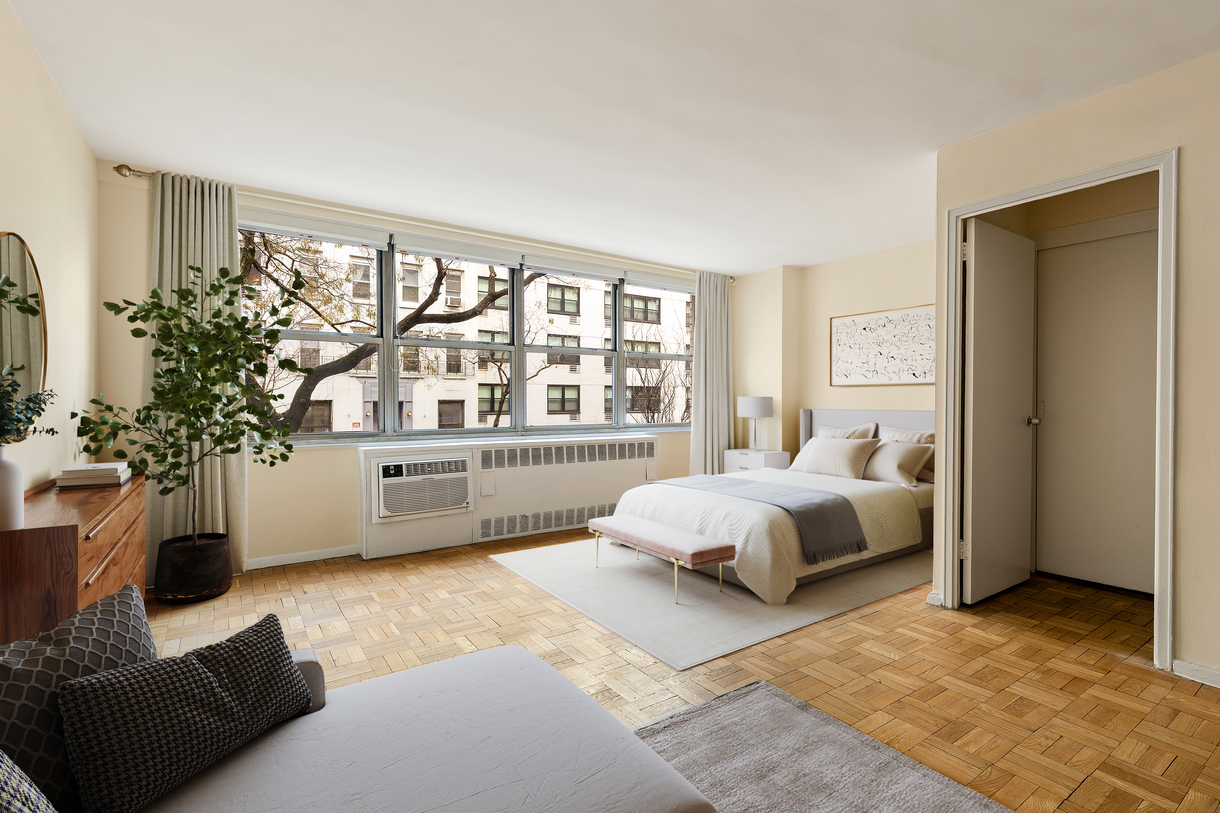 310 East 70th Street, Unit 2F Manhattan, NY 10021 - Photo 4 of 8 a spacious bedroom with a bed couch and a window