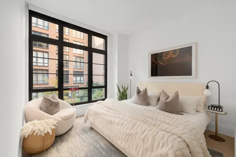 a bedroom with bed and a flat screen tv