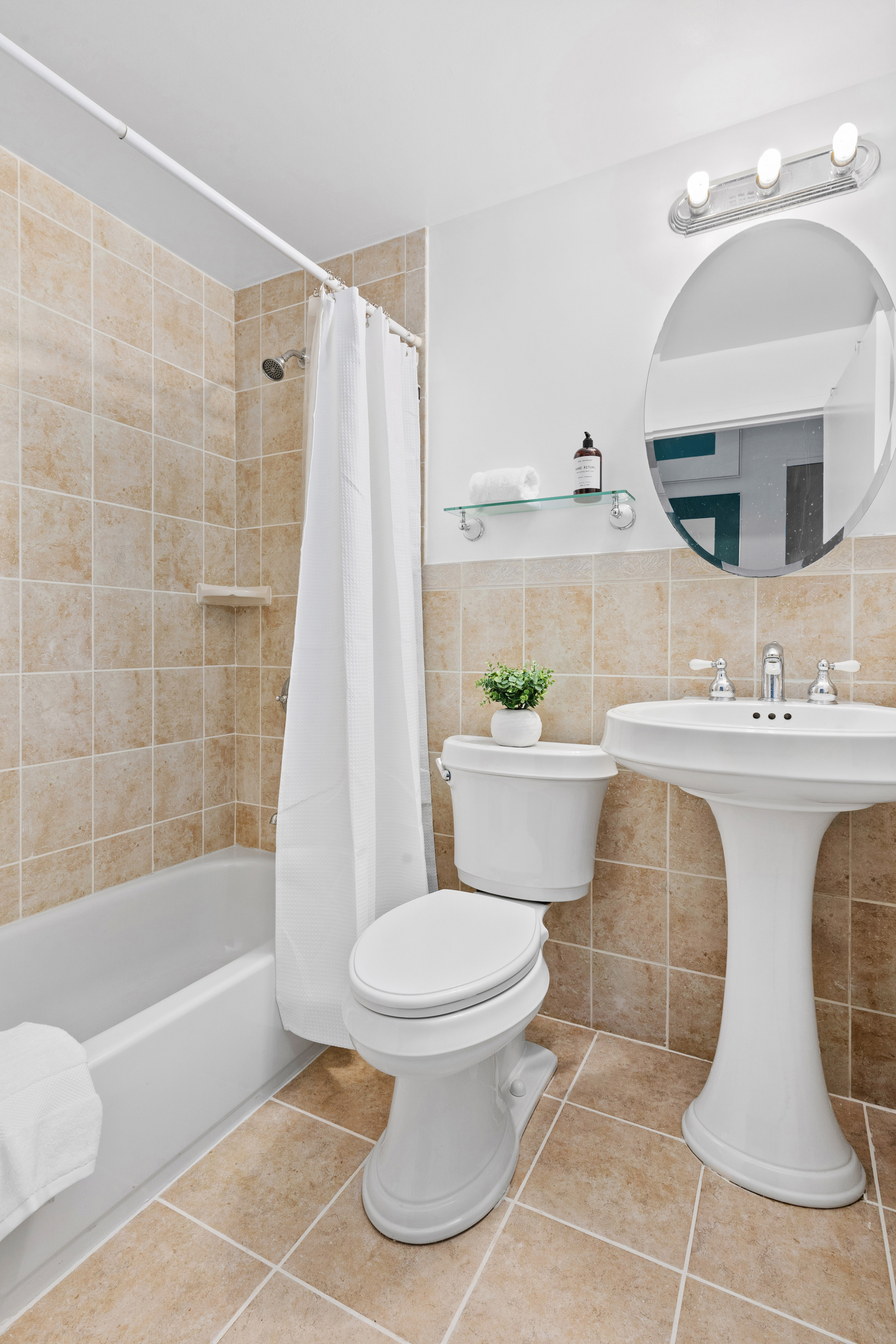 372 5th Avenue, Unit 9J Manhattan, NY 10018 - Photo 8 of 13 a bathroom with a sink toilet and shower