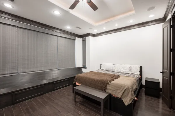 a bedroom with a bed and a ceiling fan