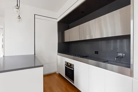 a kitchen with stainless steel appliances a refrigerator a stove and a microwave