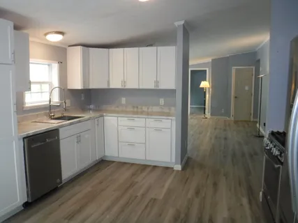 a kitchen with a sink window and cabinets