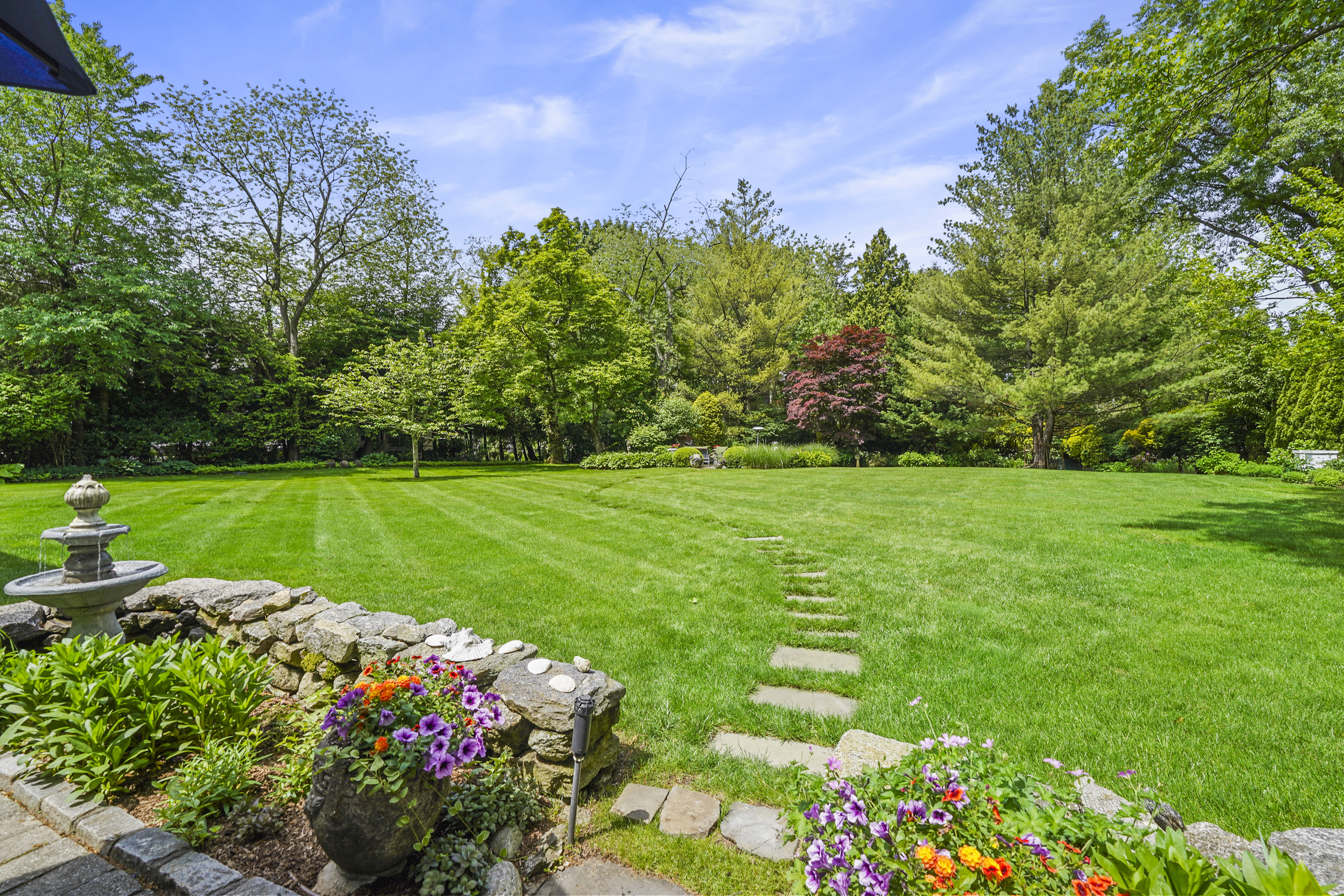 19 Avon Road Larchmont, NY 10538 - Photo 26 of 35 a view of a garden with flowers and trees