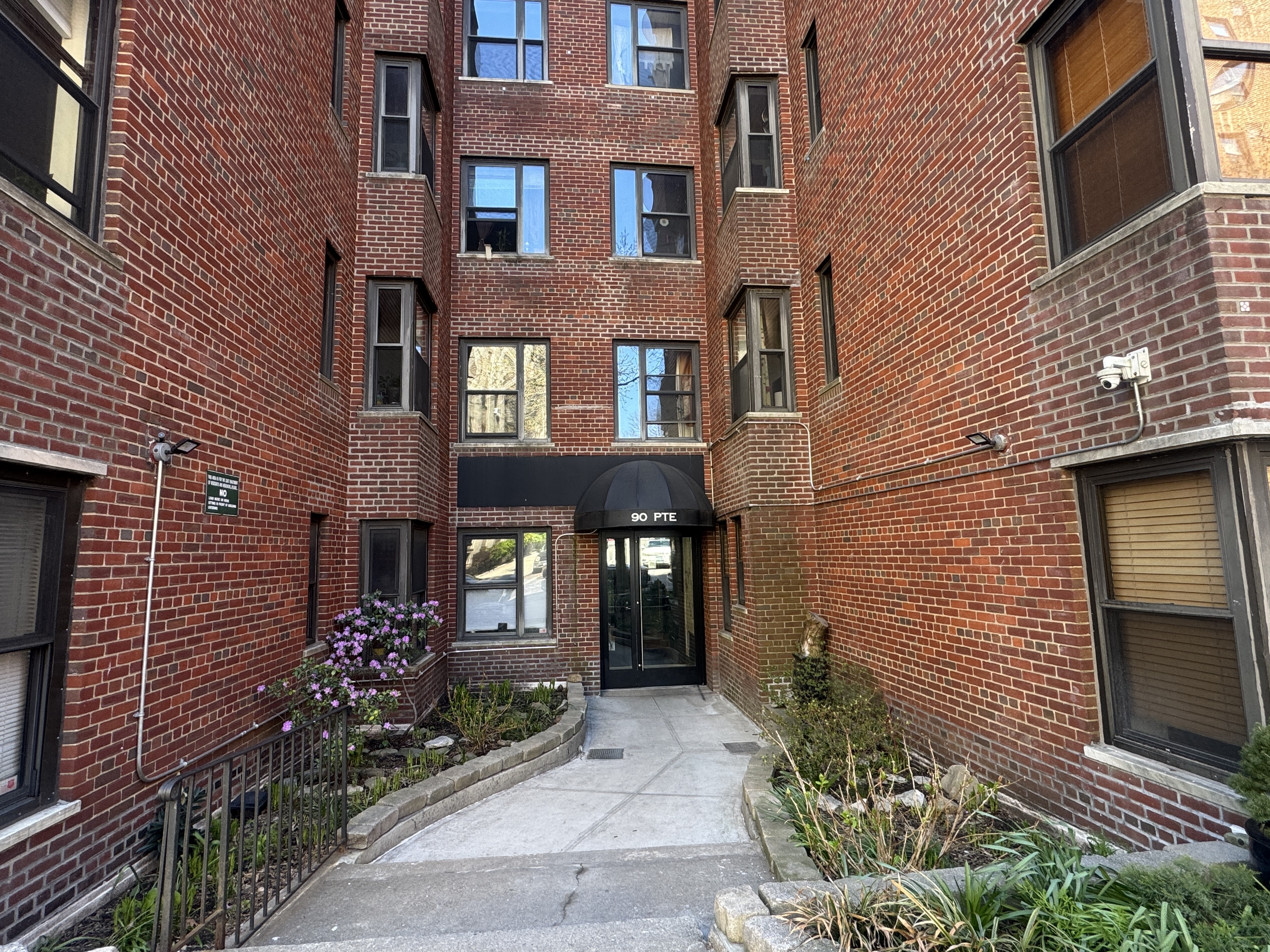 90 Park Terrace East, Unit 3B Manhattan, NY 10034 - Photo 8 of 13 a view of a brick building with many windows