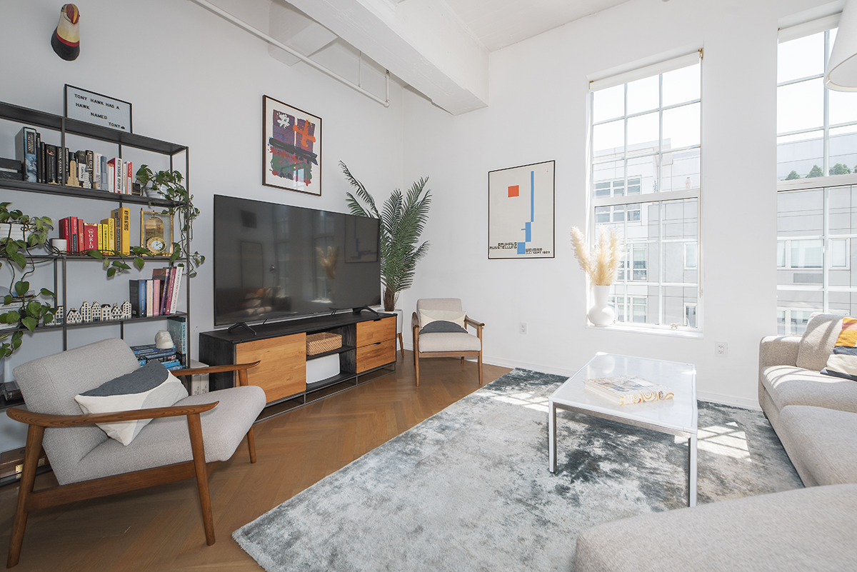 184 Kent Avenue, Unit D519 Brooklyn, NY 11249 - Photo 2 of 17 a living room with furniture and a flat screen tv