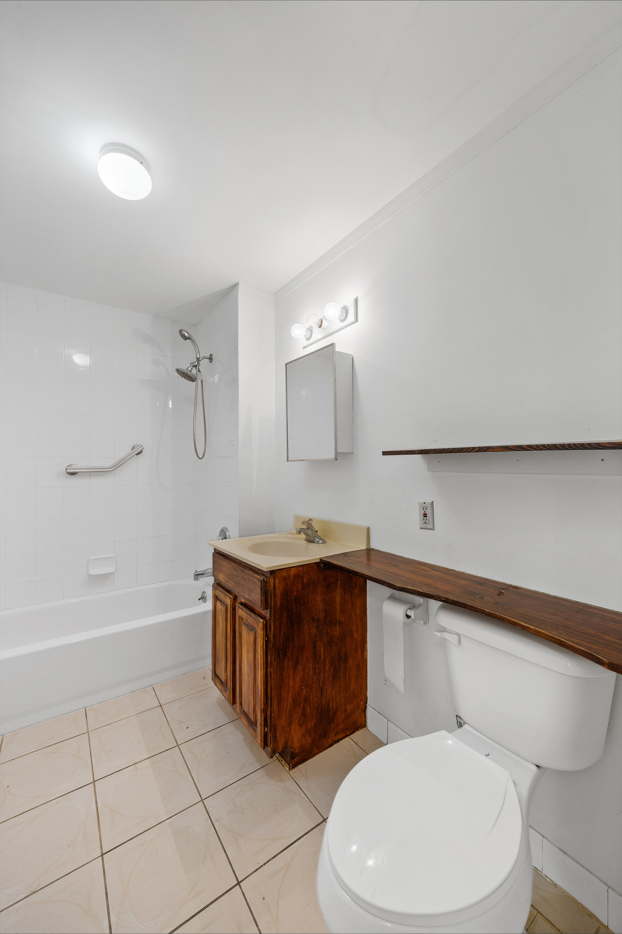 2028 Bergen Street, Unit 1 Brooklyn, NY 11233 - Photo 4 of 9 a bathroom with a sink a toilet and bathtub