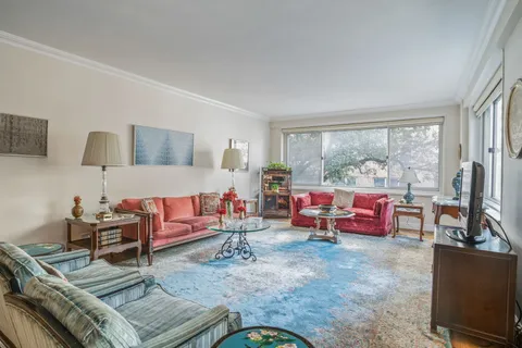 a living room with furniture and a floor to ceiling window