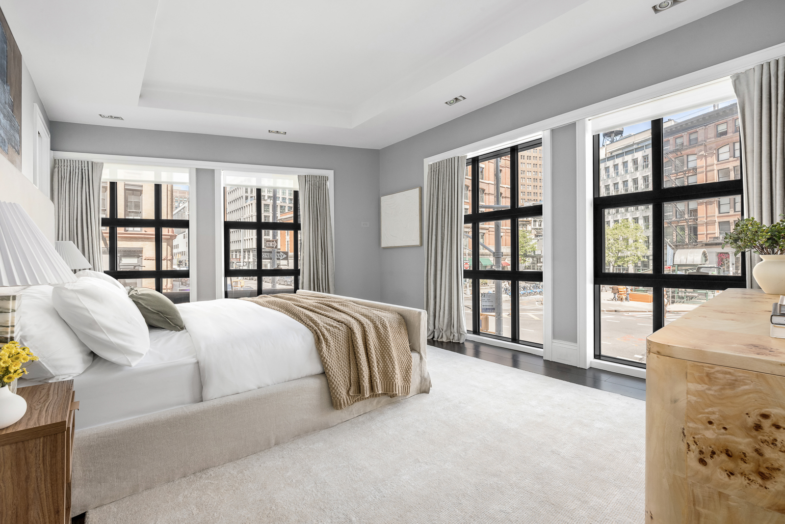 137 Franklin Street, Unit 1 Manhattan, NY 10013 - Photo 10 of 25 a spacious bedroom with a bed and glass windows