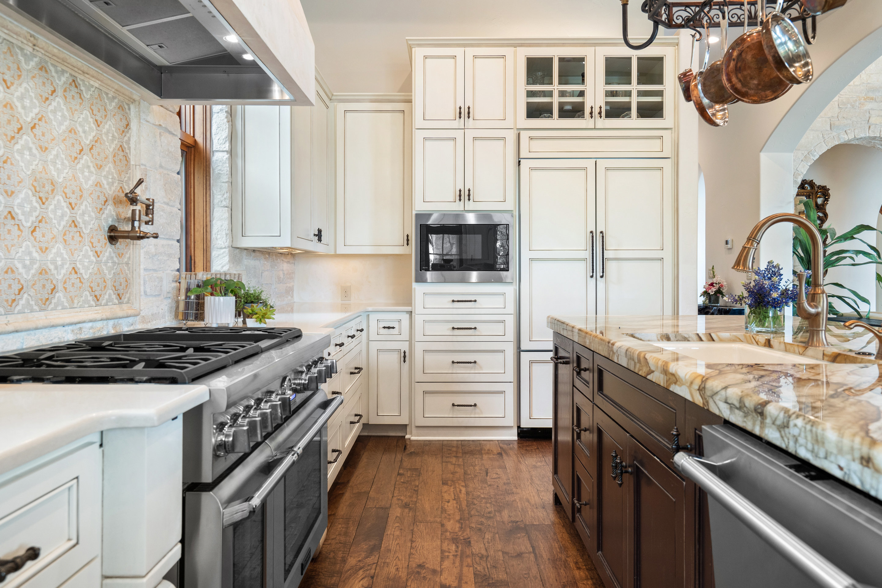 808 Rivercliff Drive Spicewood, TX 78669 - Photo 15 of 71 a kitchen with stainless steel appliances granite countertop a stove and a sink