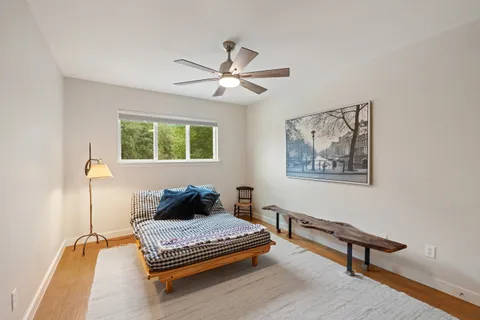 a bathroom with a granite countertop sink toilet and mirror