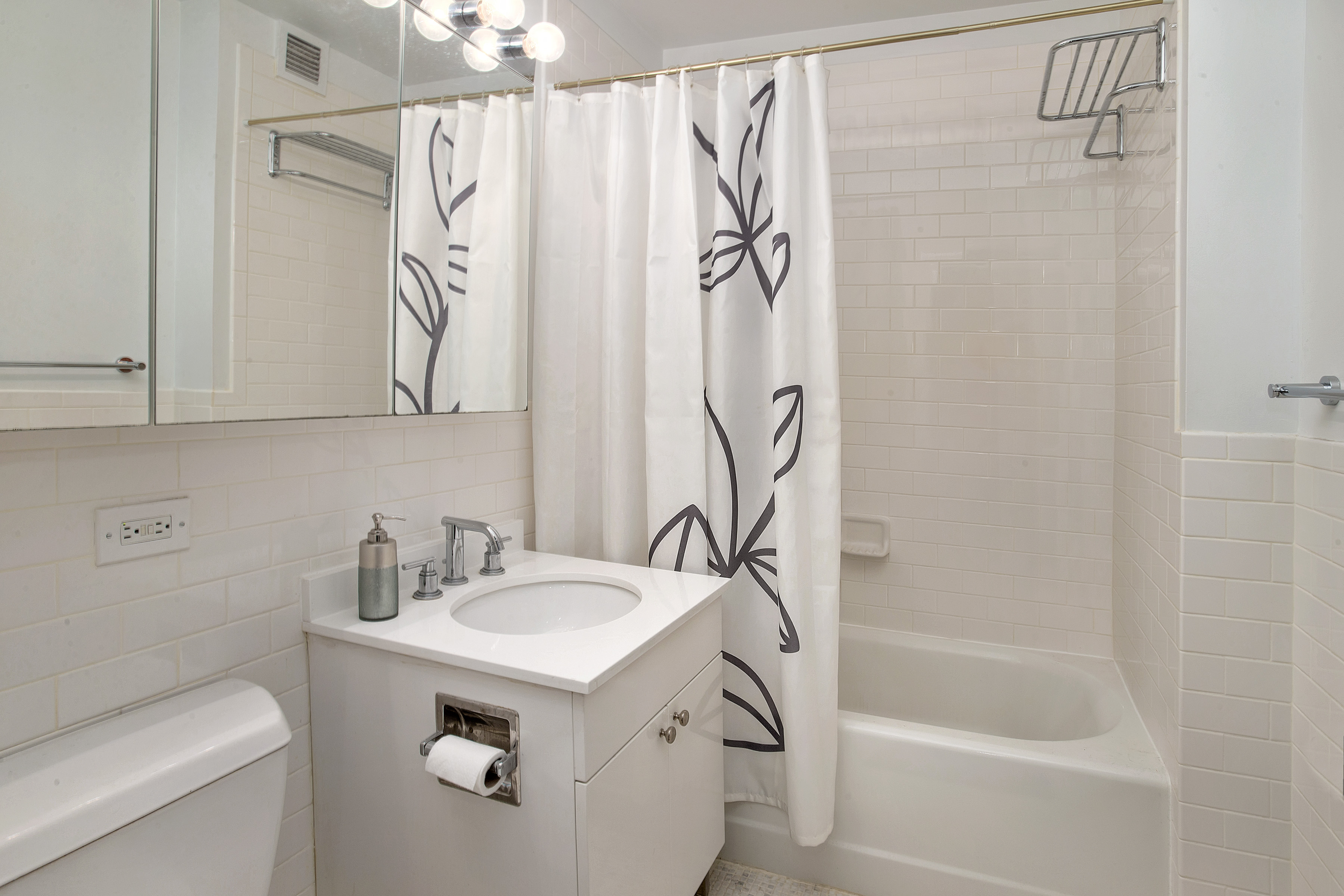 99 John Street, Unit 208 Manhattan, NY 10038 - Photo 5 of 18 a bathroom with a shower a sink and a mirror