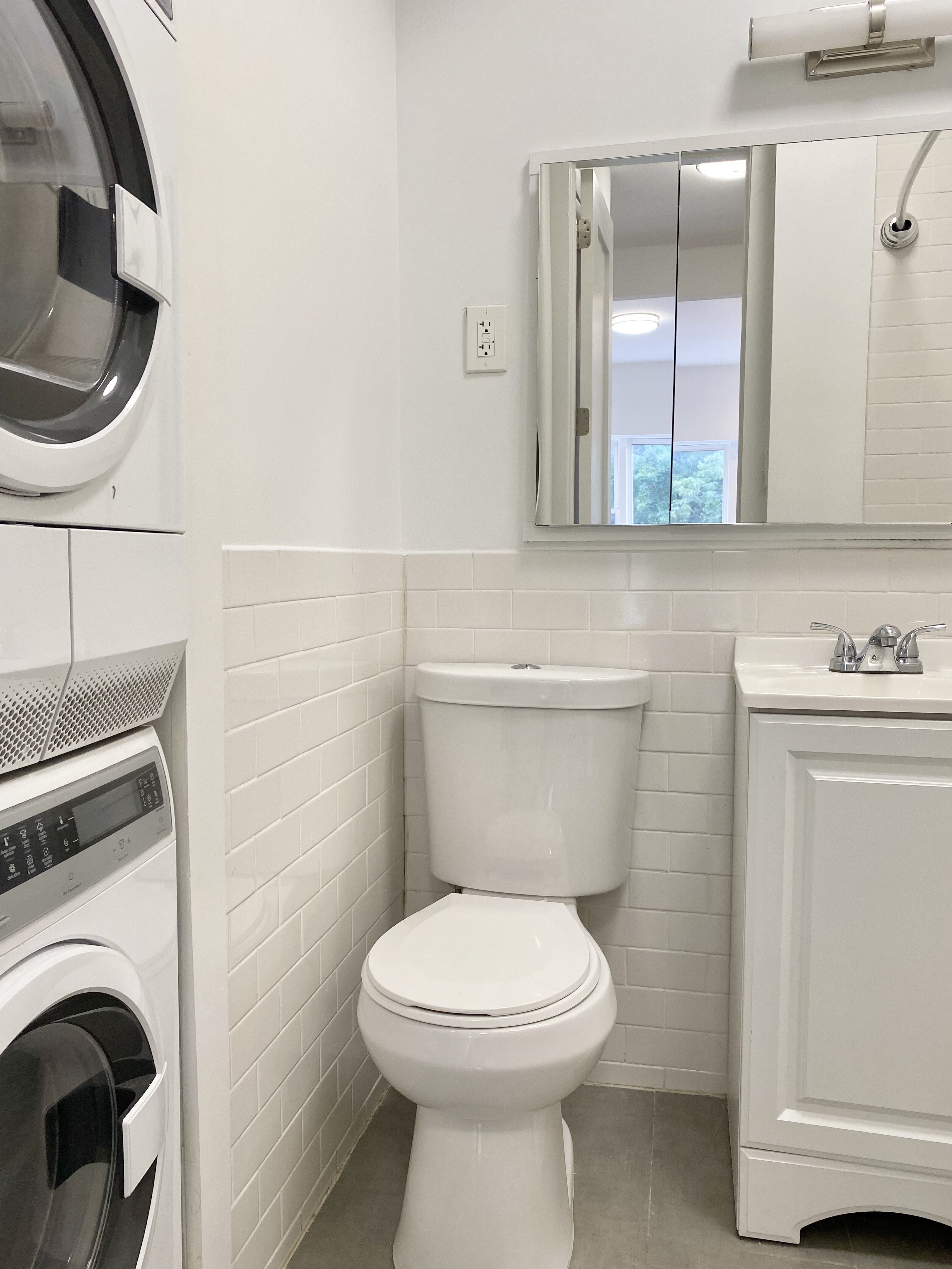 1734 2nd Avenue, Unit 3A Manhattan, NY 10128 - Photo 7 of 8 a bathroom with a toilet a sink and a mirror