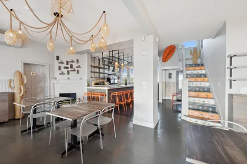 a large living room with stainless steel appliances granite countertop furniture and a wooden floor
