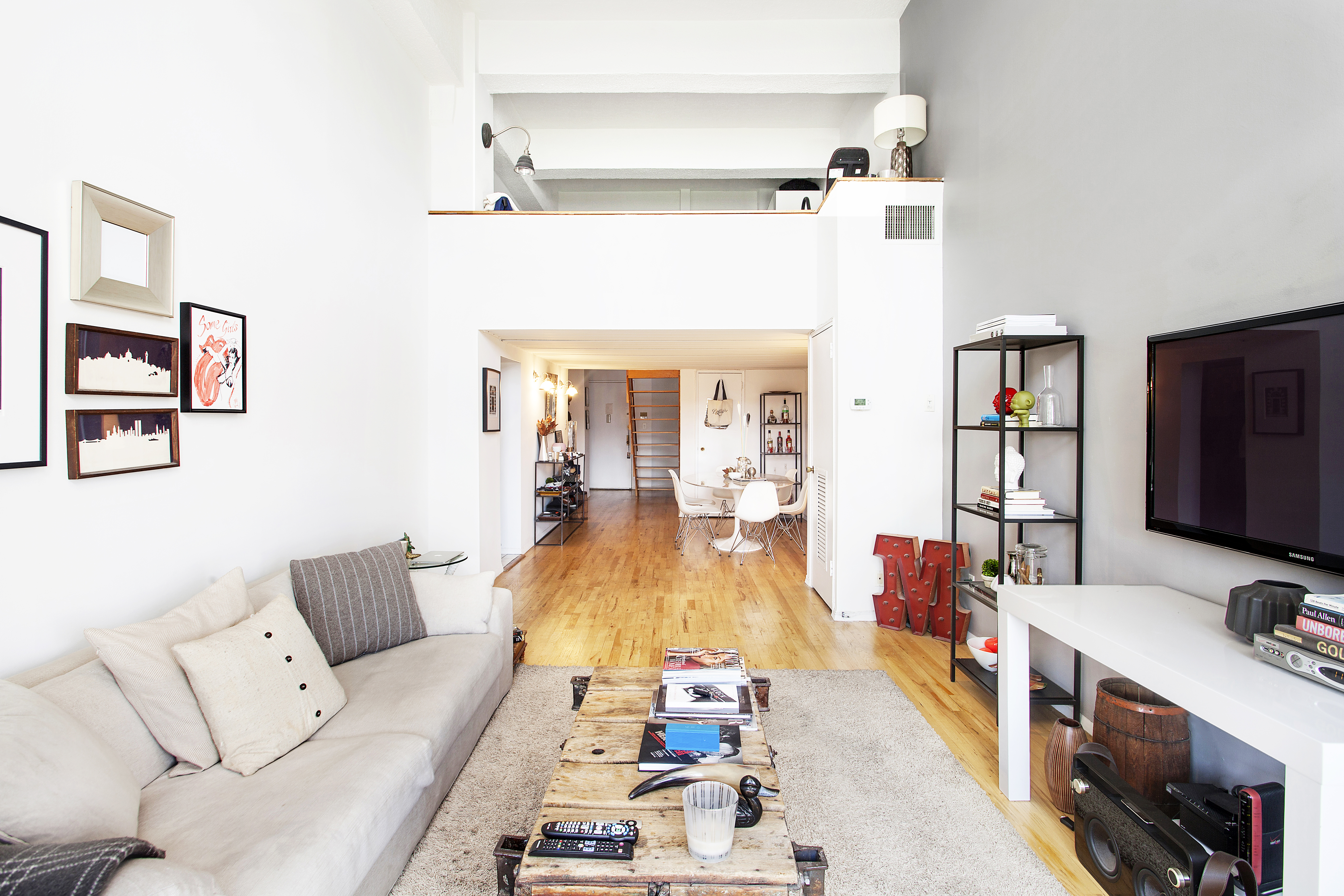 421 Hudson Street, Unit 508 Manhattan, NY 10014 - Photo 2 of 5 a living room with furniture and a flat screen tv