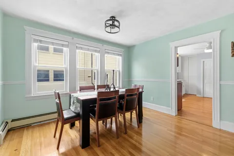 a view of a dining room with furniture and wooden floor